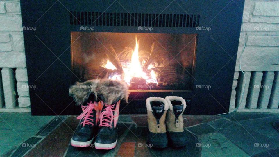 winter snow boots by the fireplace