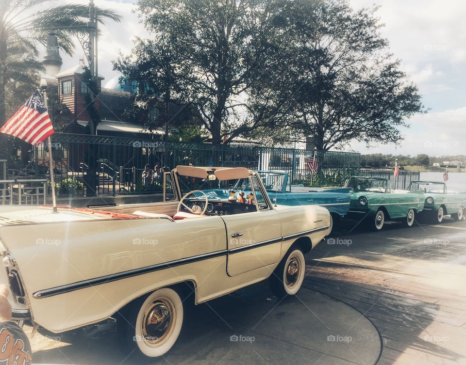 Amphibious vintage convertible cars at Disney Springs lined up on the ramp to go for a ride on the lake
