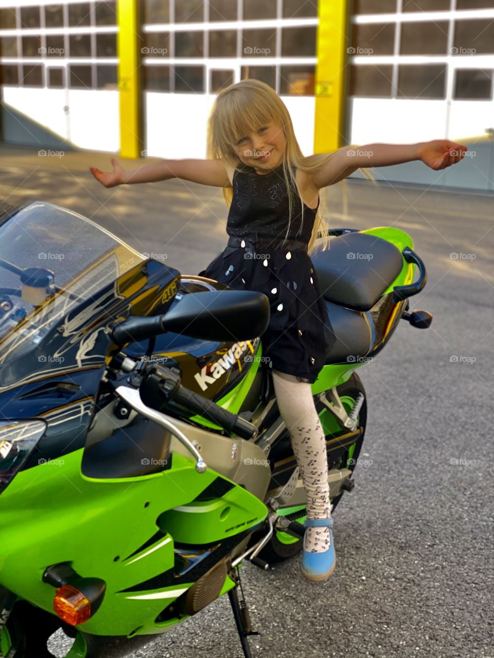 blonde girl on a green sport motorcycle