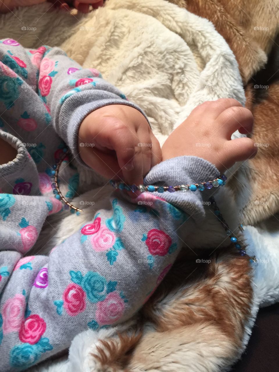 Baby playing with Grandma's bracelets