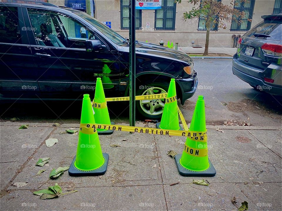 Next to the parked black car is a small section marked off by plastic cones and barricading tape on „Waverly St“ in „Clinton Hill“, Bklyn. Wonder what they’re guarding ? 2022. Hypnotic Productions