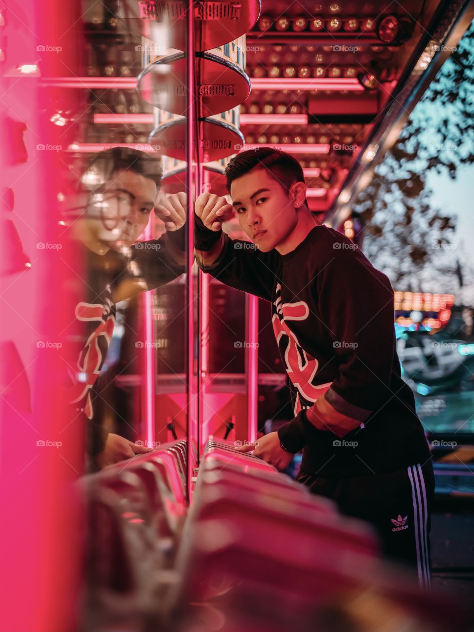 Artistic portrait shot at a game station inside a carnival with red colour theme