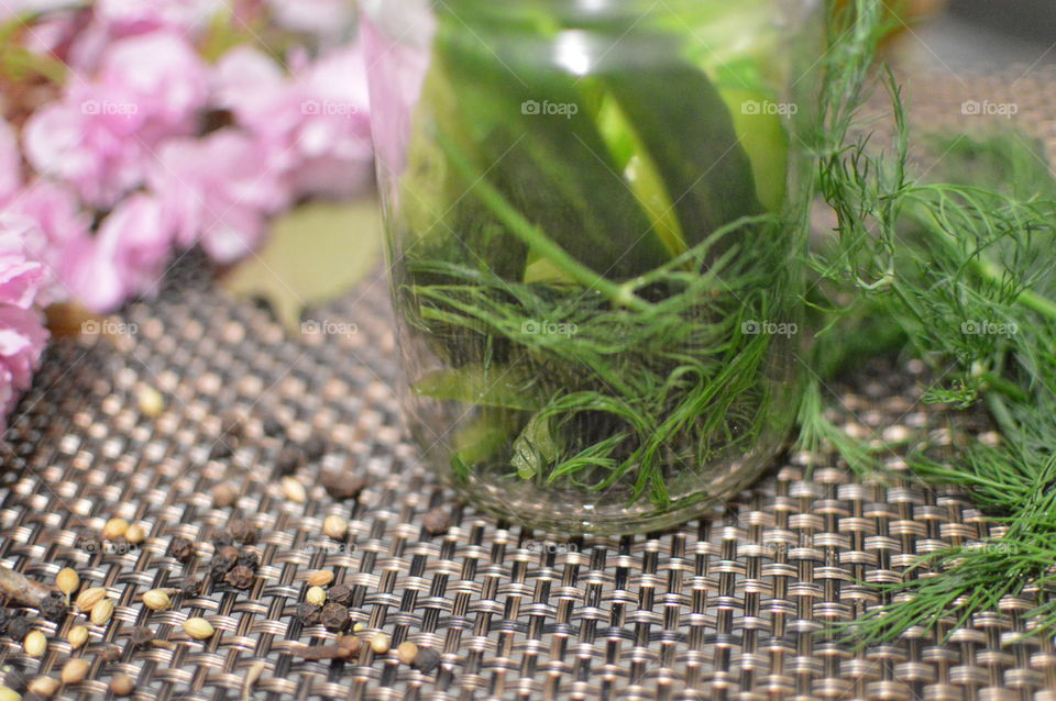 Close-up of cucumber pickle with herb