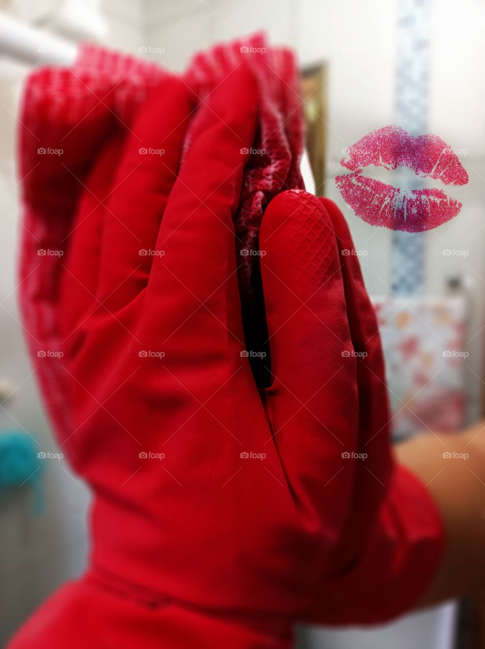 Mirror cleaning with red rubber gloves with lipstick mark