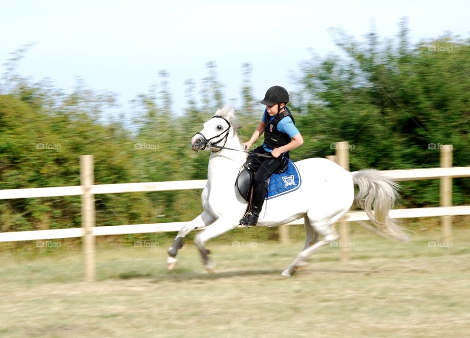 Teenage boy riding horse