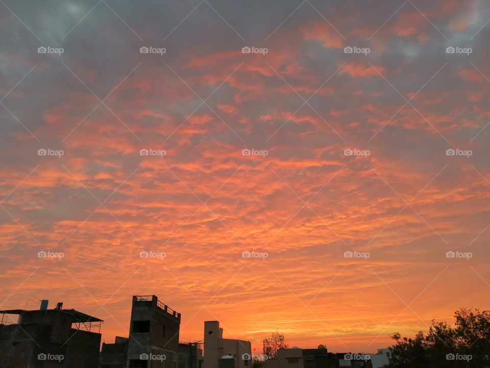 The orange colour stories. Orange colour cloudy sky at evening time.
