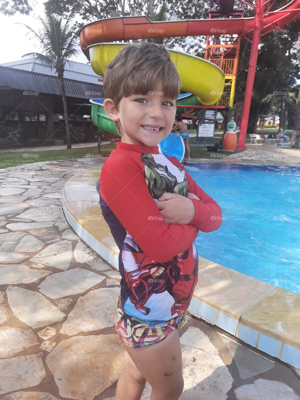child in pool clothes