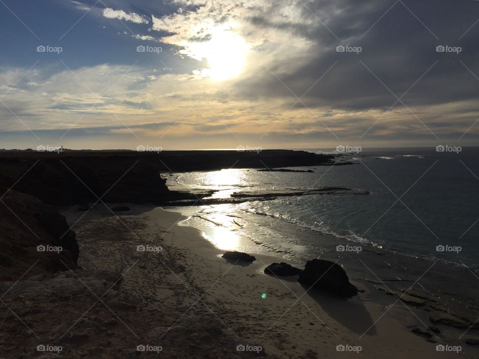 Cliffs and sea reflecting sunshine