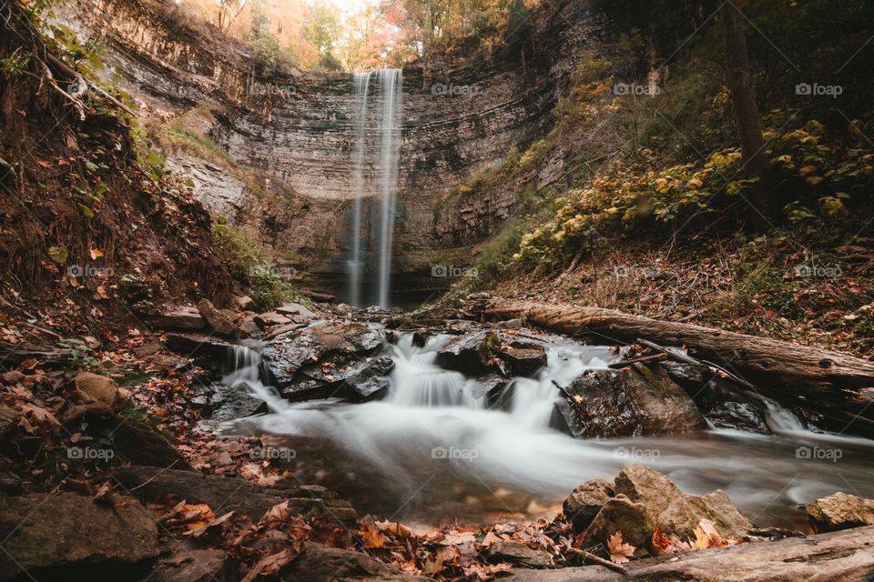 Beautiful water fall and river scenery with maple leaves