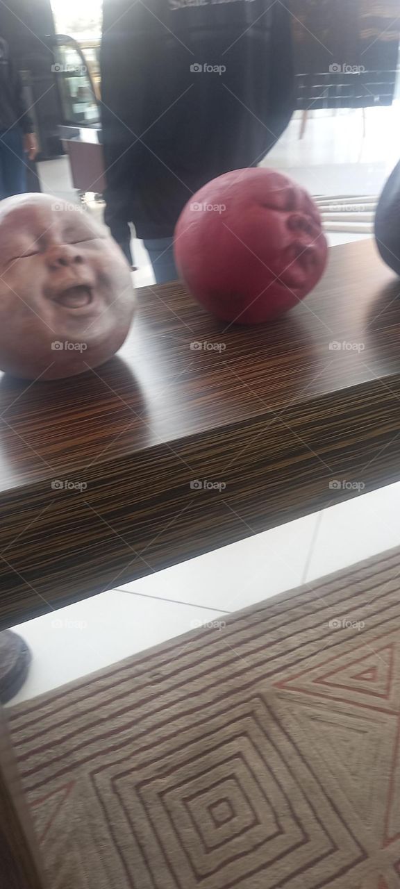 Awesome Art display of round clay faces with various expressions