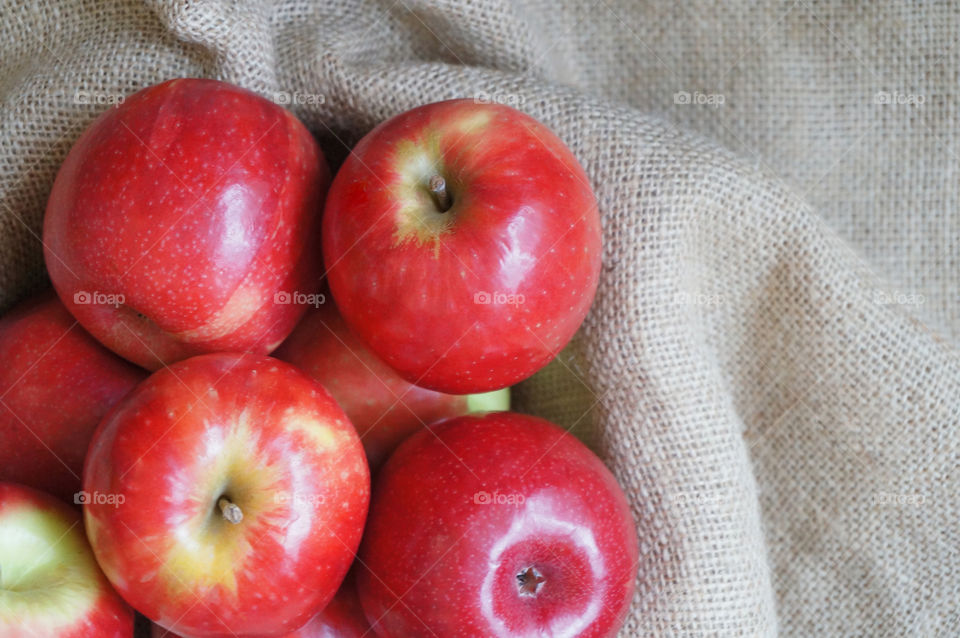 Red apples isolated on sackcloth background 