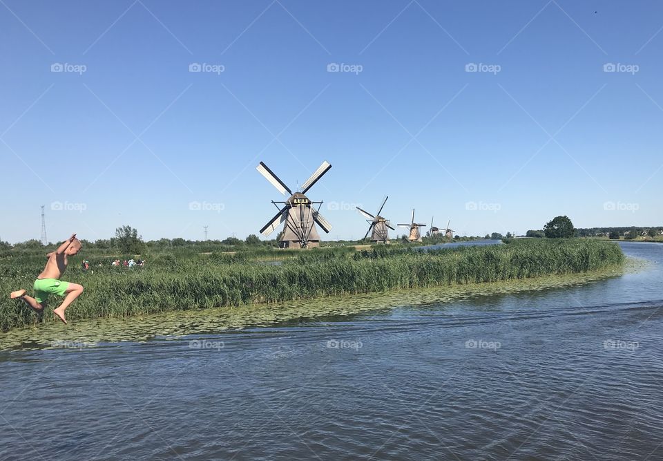 A tranquil summer afternoon at Kinderdijk, a UNESCO World Heritage site for its famous windmills dating from the 15th century. 
