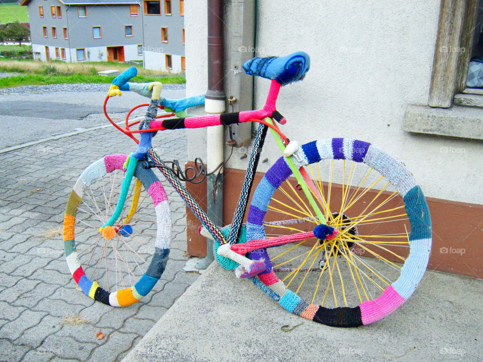 sweater weather. bicycle in a multicolored sweater