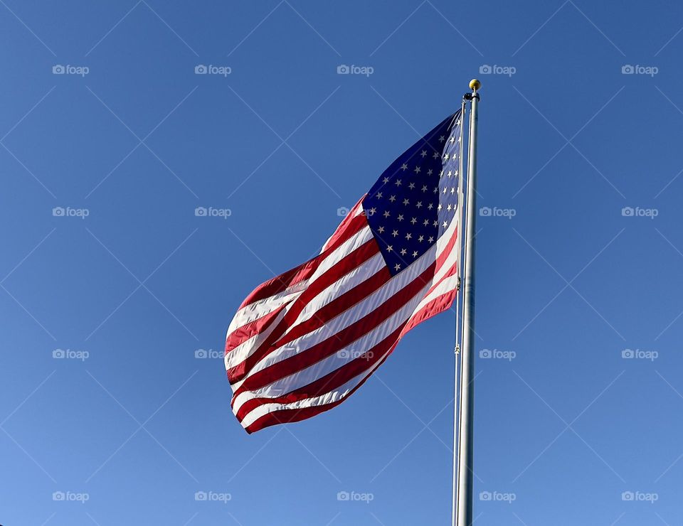 American flag on the blue sky background 