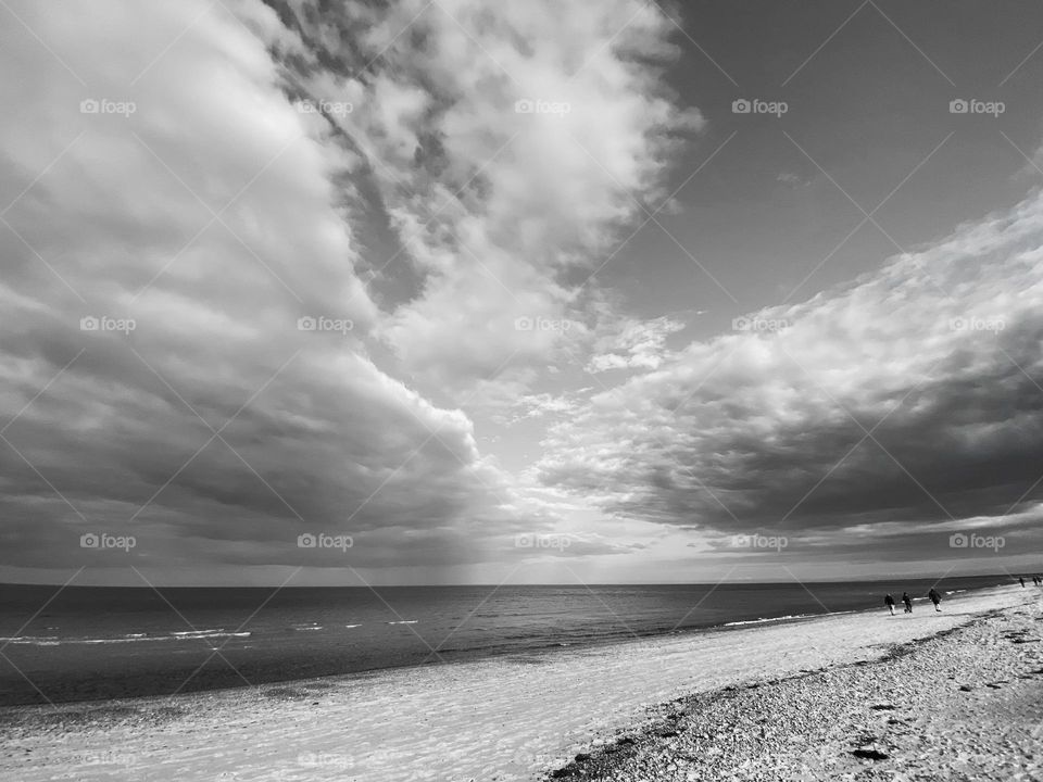 Clouds mission - large banks of storm. Louis hover over the ocean, rain way back on the horizon.  