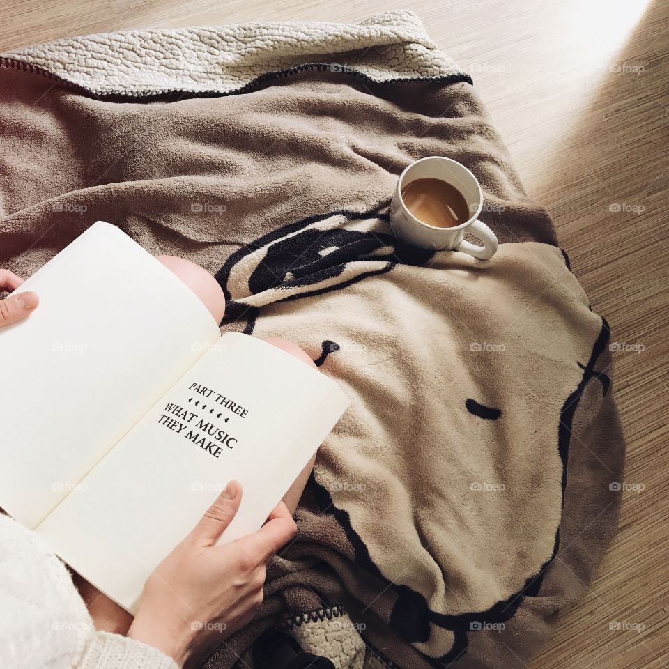 Girl reading book and drinking coffee