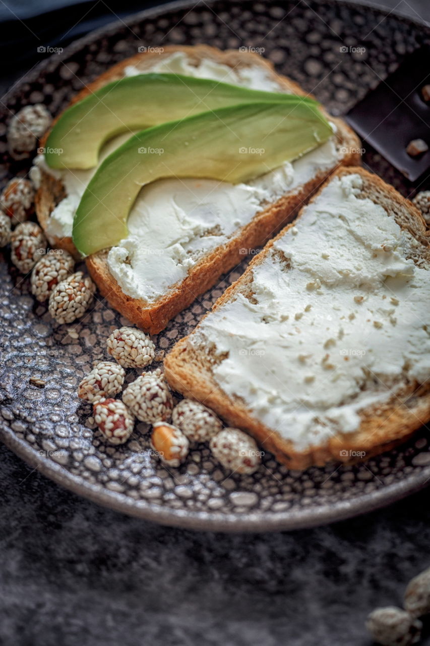 Dietary sandwiches of grain toasts with cream cheese and avocado