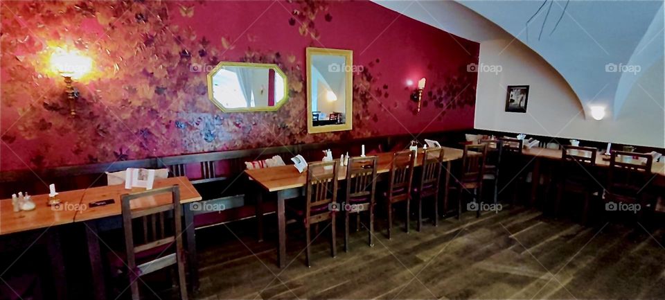 This is one of the dining rooms at the gourmet restaurant of “Schloß Blumenthal”, “Castle Blumenthal” in “Aichach”, “Bavaria”, Germany. The burgundy wallpaper with embossed satiny pattern is in style with tradition. 2024. Hypnotic Productions