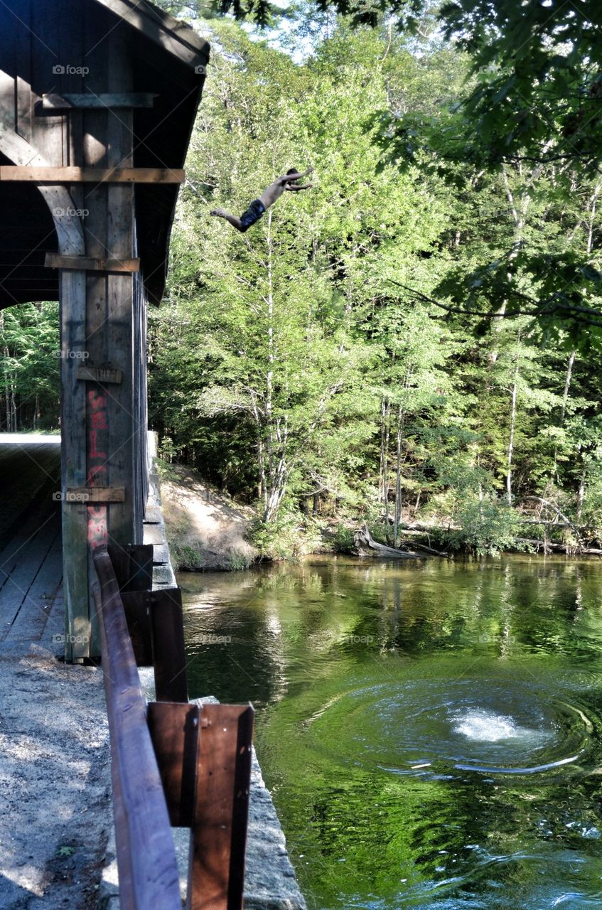 Jumping off covered bridge