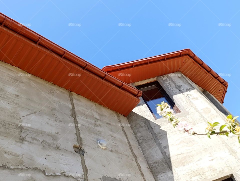 orange roof against blue sky.