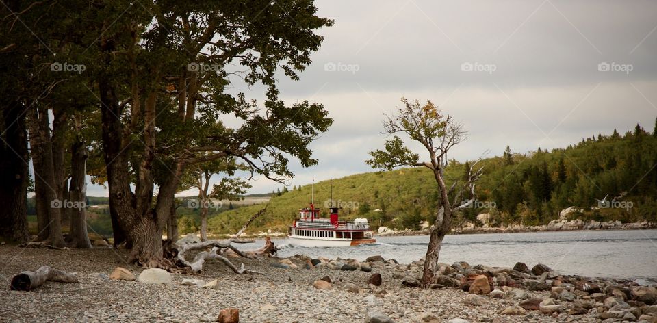Watching the ferry go by on the beach in Waterton National Park, Alberta