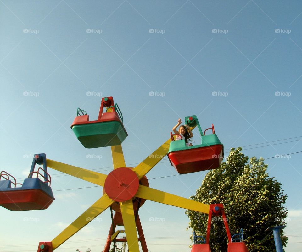 girl rides carousel