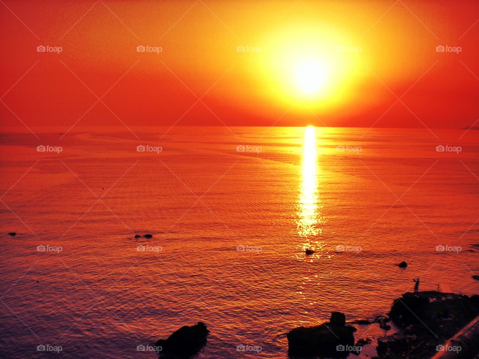 Sun reflecting on sea during sunset