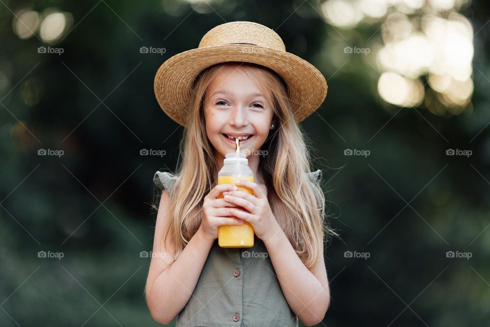 Girl drinking juice outdoor 