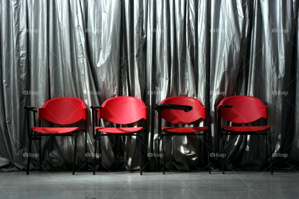 four empty red chairs