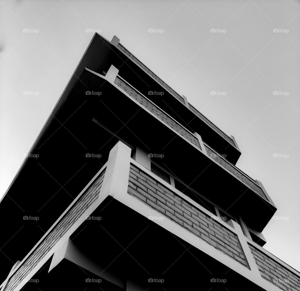 Low angle exterior shot of a building in black and white