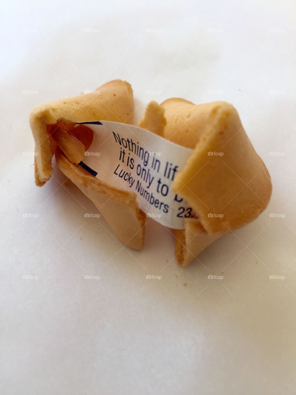 Fortune cookie. Fortune cookie cracked open with message inside