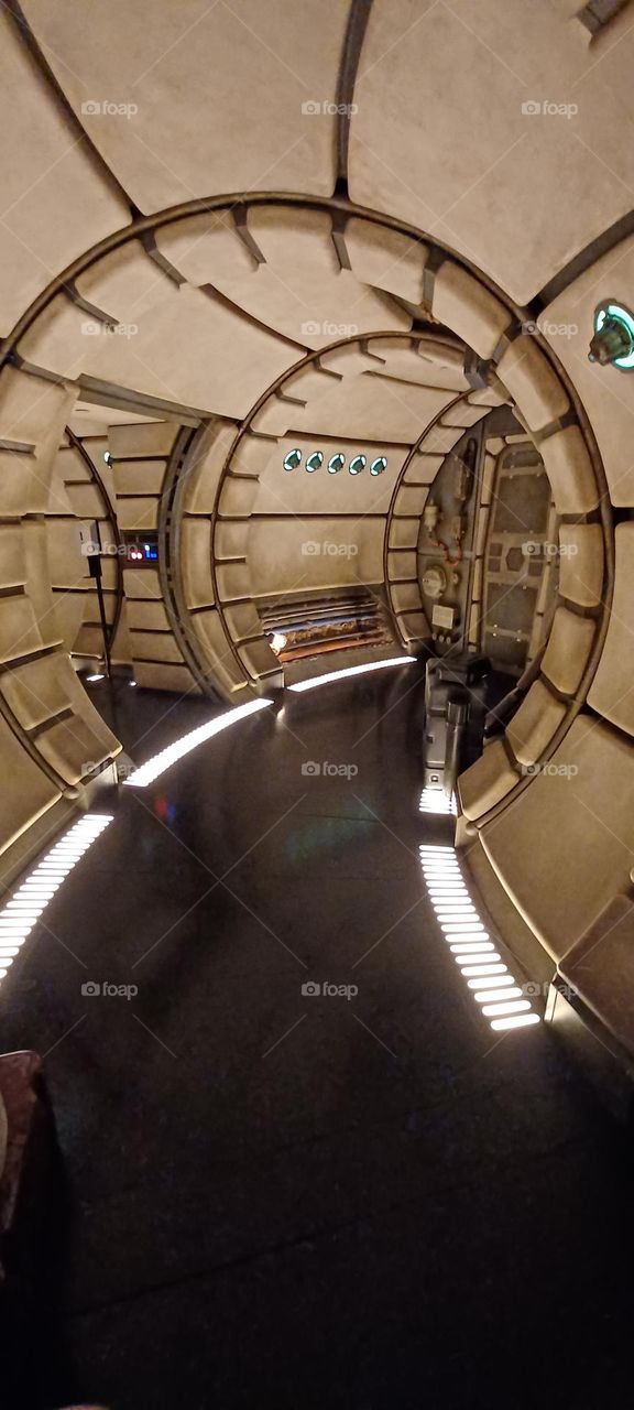 Inside the star wars space station ride in universal, round structured walls and lighting in the floor with deep molding and sleek walkways