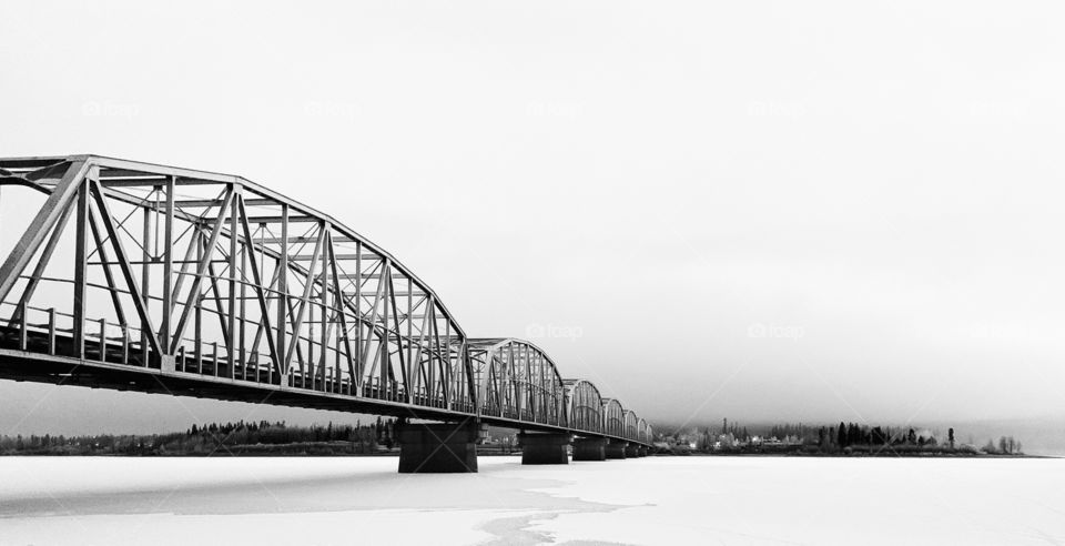 Bridge across snow and ice covered Teslin Lake. 