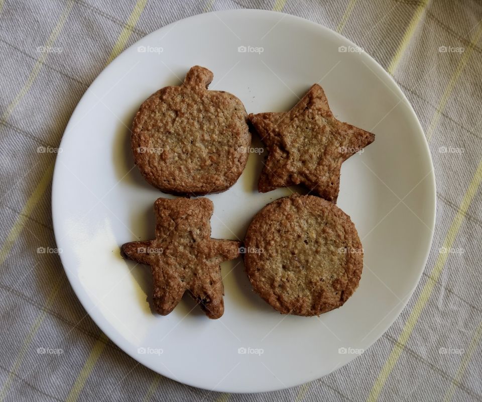 Matzo meal cookies with white round plate background.