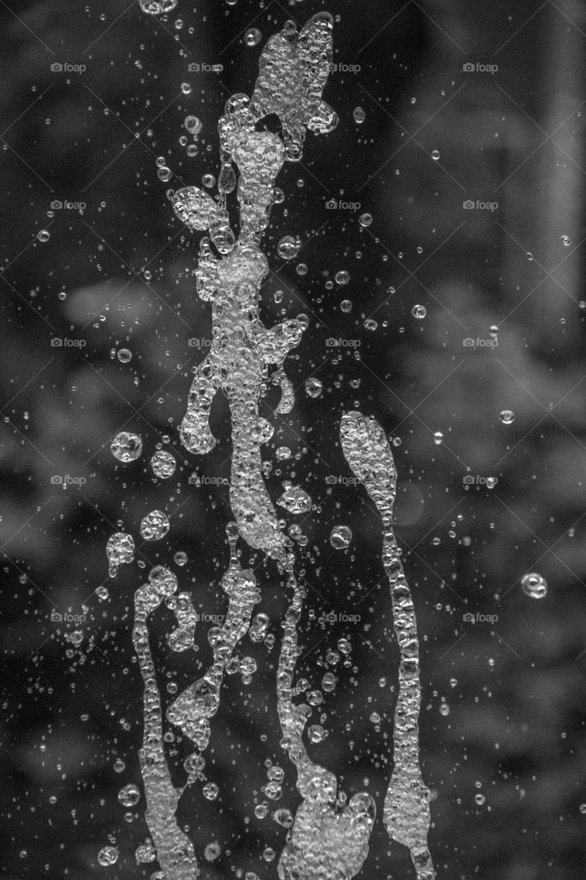 Water drops in a fountain in black and white 