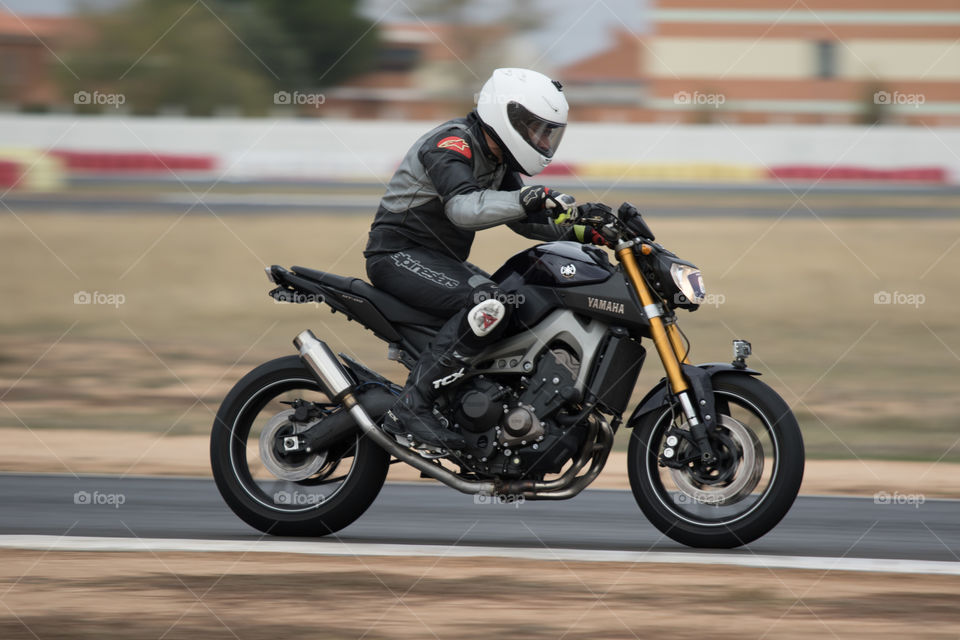 Black sportbike and rider on circuit