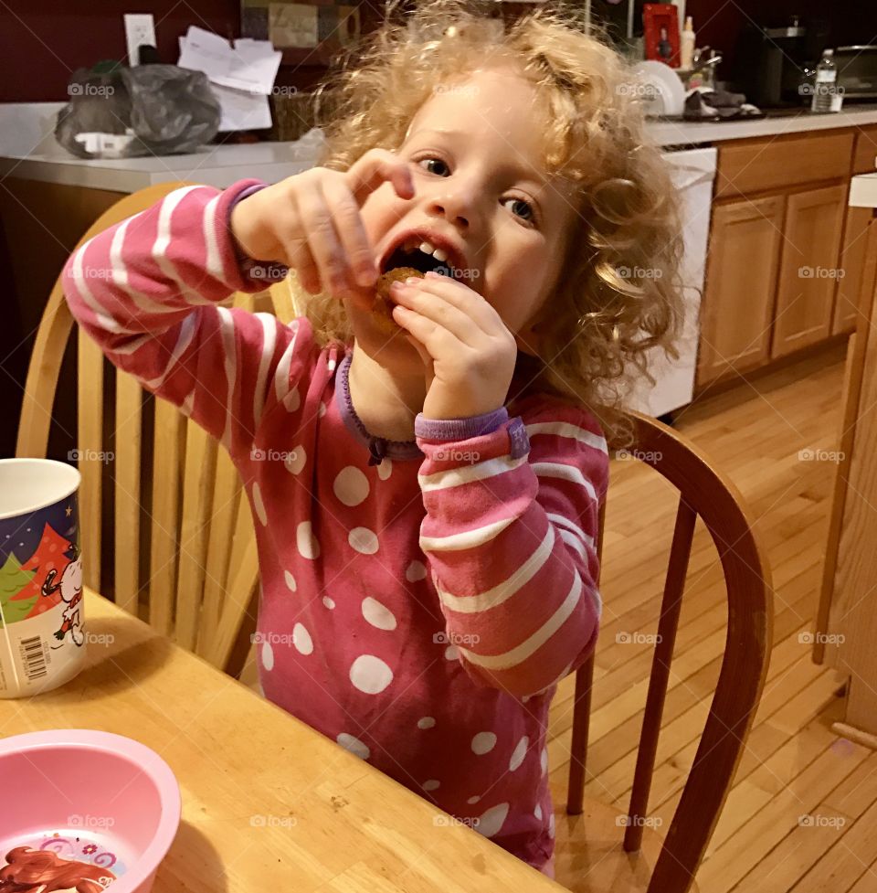 Portrait of a small girl eating
