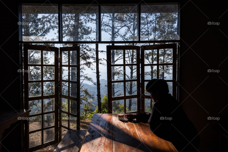 Man chilling in the room with view outside the window