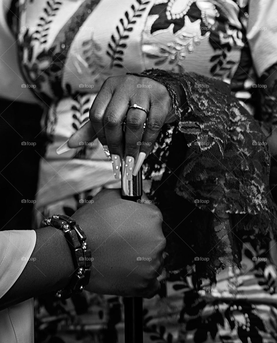 Two hands intertwined, symbolizing a lifelong bond and unwavering commitment. The glint of wedding rings catches the light, a testament to the love and shared journey of a married couple. A beautiful moment of connection, captured in time by me.