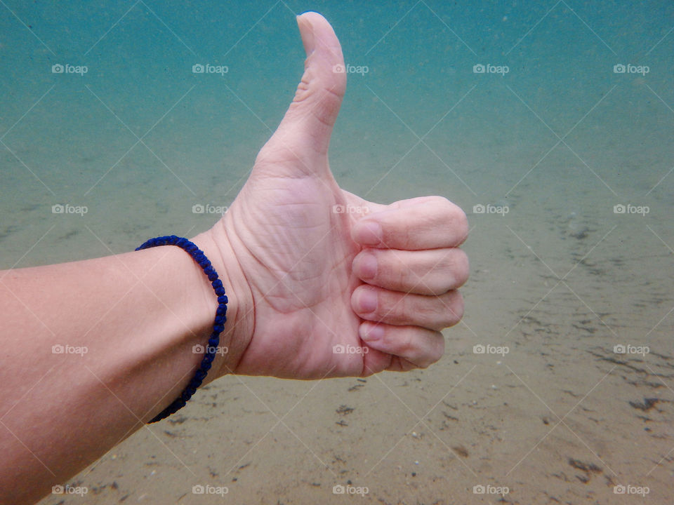 ok sign underwater. hand making sign ok underwater