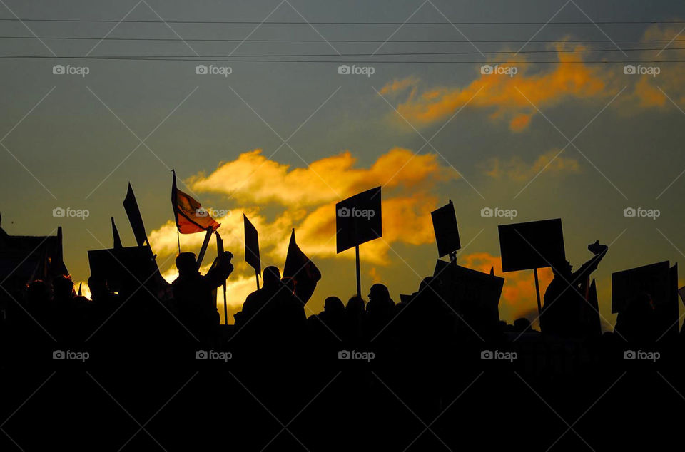 silhouettes of people at a street demonstration