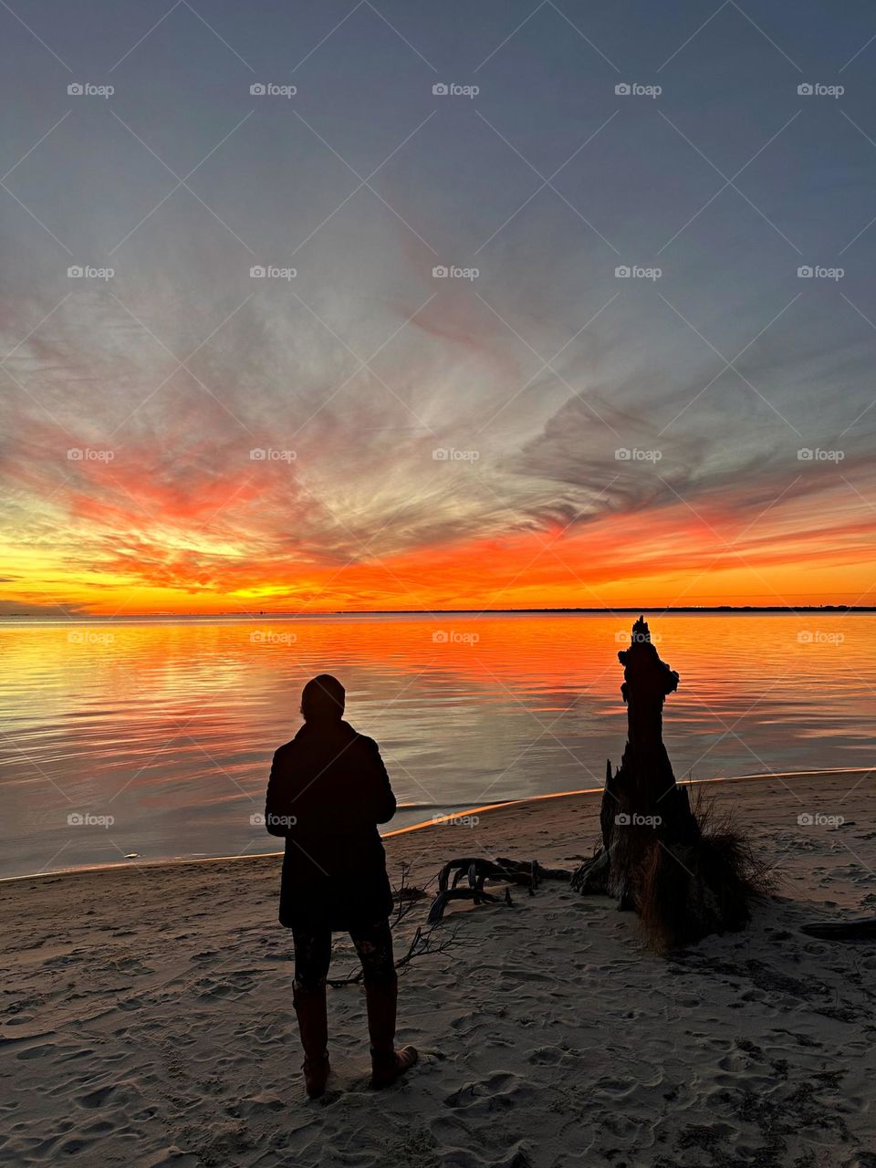 Magic of the Sunset - A young lady photographs sunset. The radiance of the beautIful peach colored sky from the descending sunset was glorious to behold and increasing every moment in splendor. 