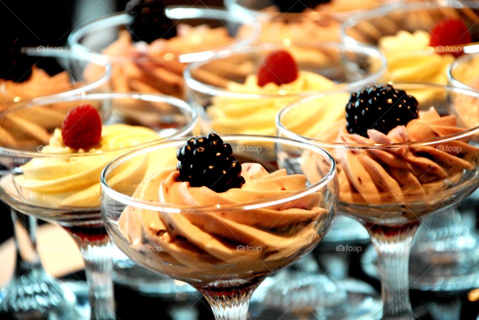 Mousse served in glass giblets topped with a berry