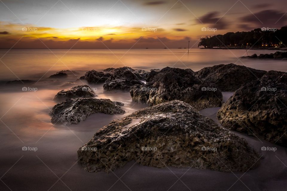 Sunset and rocks at sea