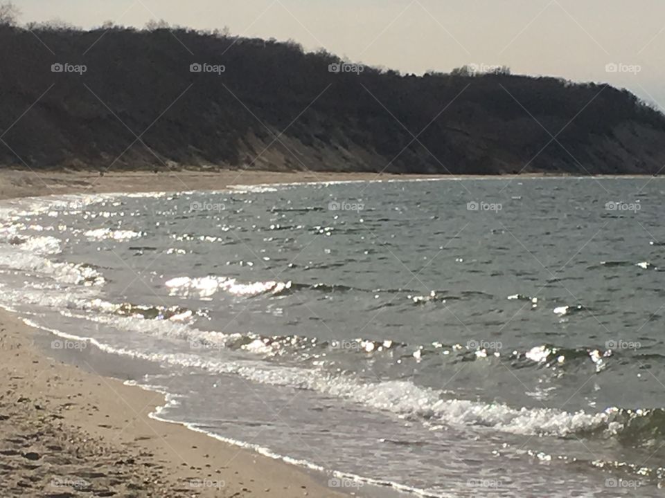 Water glistening on the beach.