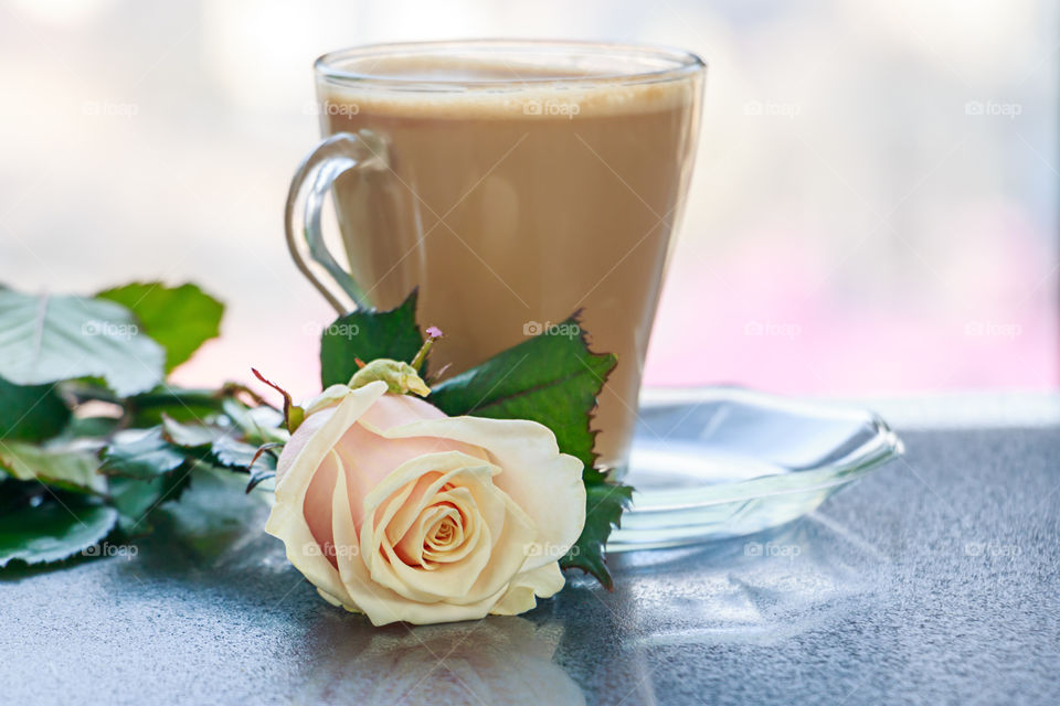 Cup of coffee with rose