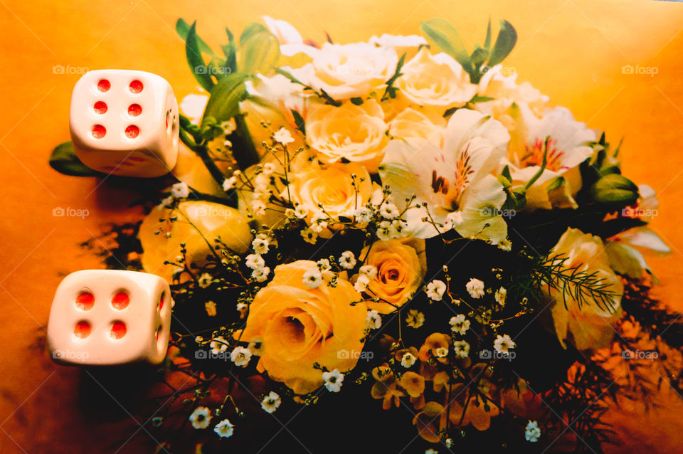 Selective focus on dices: Casino dice set. Number 6 dices on colorful background. Red gaming dices on flower background. Room for text. Game concept. Can be used for home decor.