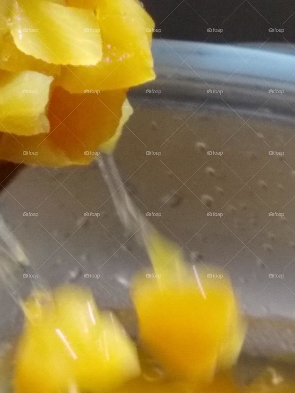 Peach chunks in water💦, going in the bowl.