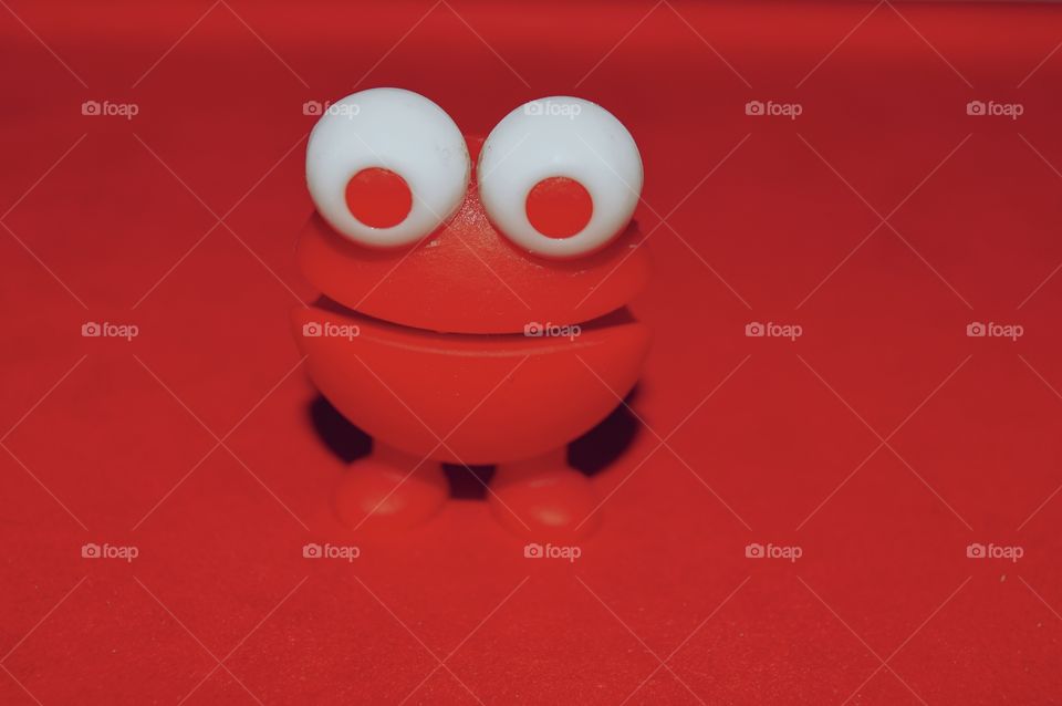 Little red toy on red background