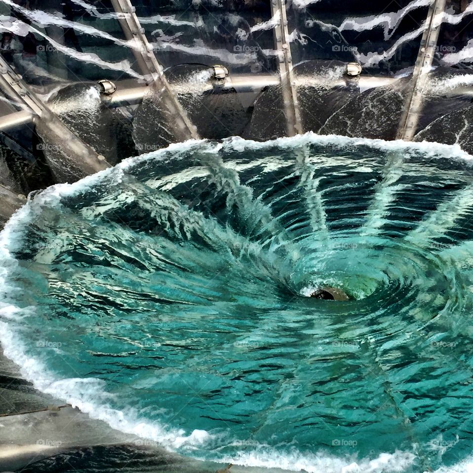 Water swirling in a giant pool displaying coriolis effect 